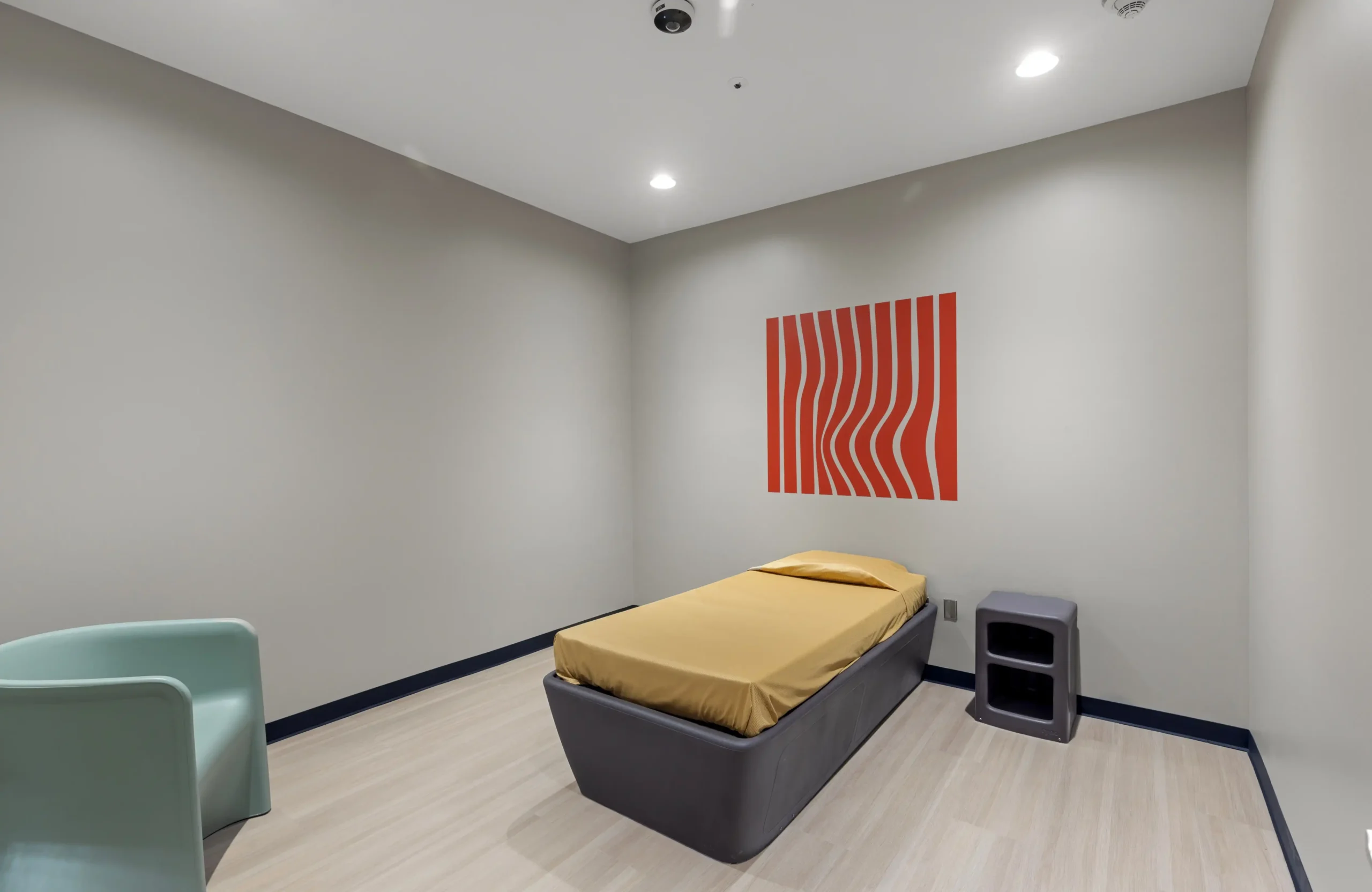 Patient rooms are designed to balance safety, comfort, and dignity. Ligature-resistant furniture, seamless finishes, and rounded edges reduce risks, while durable materials withstand daily use. Neutral colors and calming design elements create a therapeutic setting that supports rest, recovery, and overall well-being.