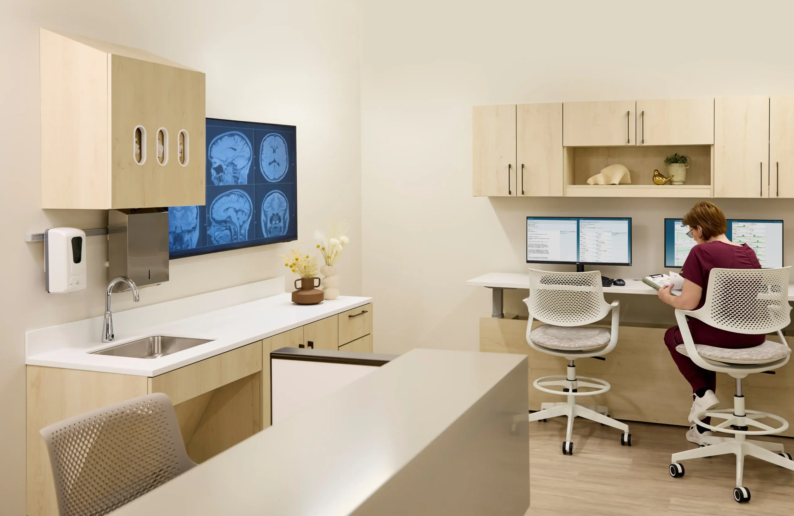 Work areas designed for caregivers integrate technology, storage, and infection-control surfaces. Efficient layouts reduce time spent on tasks and allow staff to focus more on patient care, while calming finishes help soften the clinical environment.